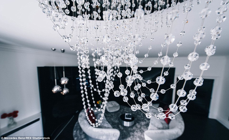  The S-shaped chandelier in the living room is made from hundreds of Swarovski crystals