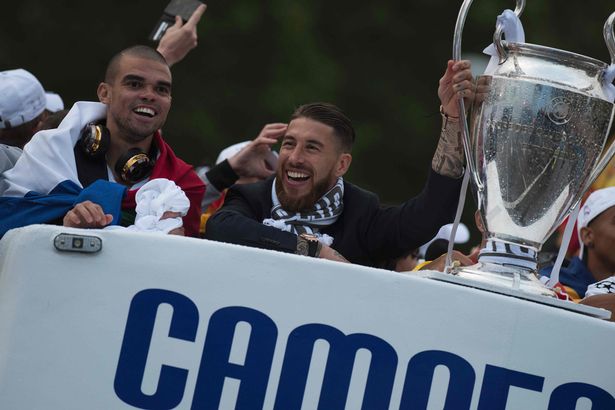 Real Madrid's defender Sergio Ramos and Real Madrid's Portuguese defender Pepe celebrate the team's win on Plaza Cibeles in Madrid on May 29, 2016