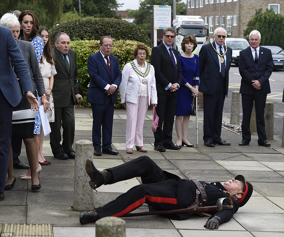 The Duchess of Cambridge (left) turns in shock as a local official falls to the ground while welcoming the royals to Essex