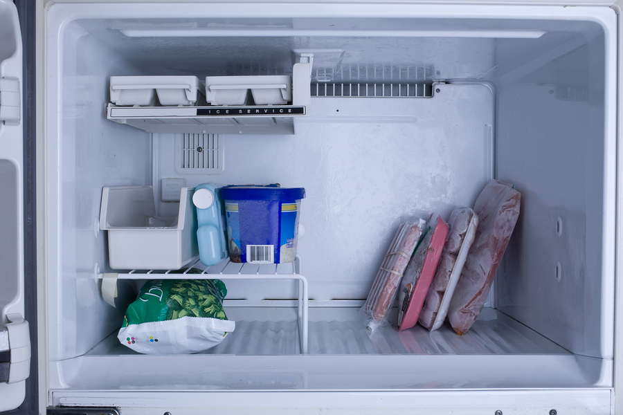 bigstock Nearly empty freezer with a co 26081732
