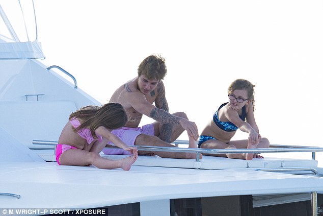  Justin happily showed his sisters a number of poses to try on board their catamaran 