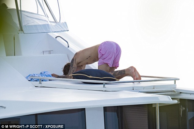  Placing his arms outright, the international music star fell to his knees as he bowed down into child's pose to finish his mental and physical workout