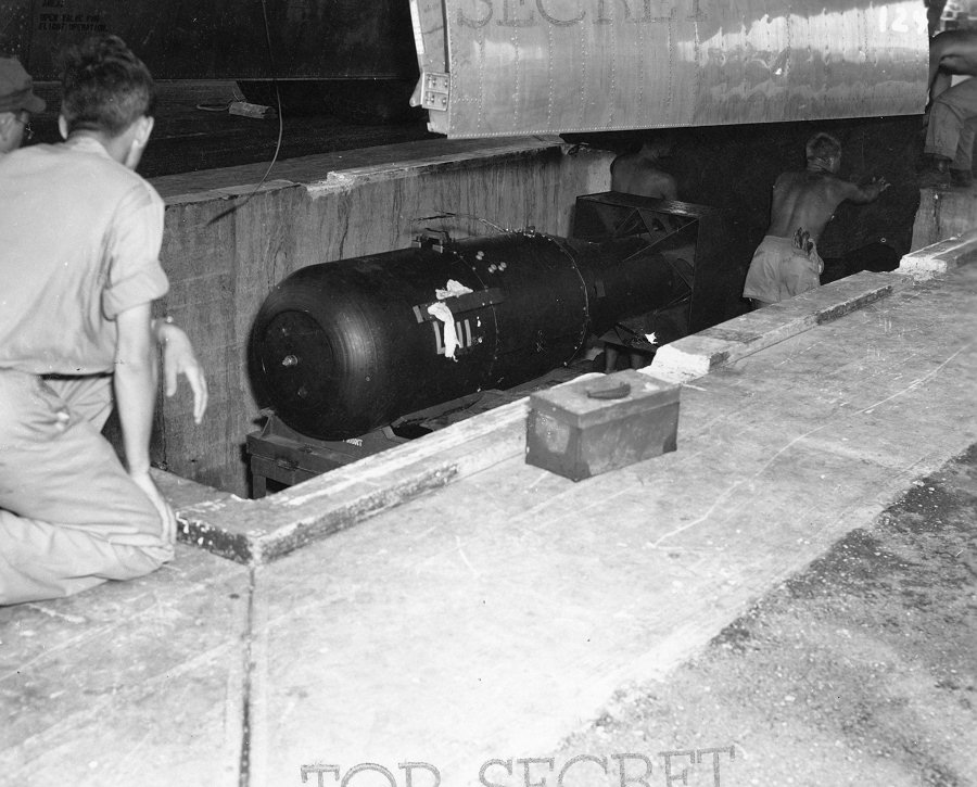 The tarp is removed and the bomb is readied for loading.